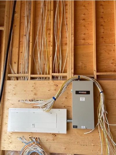 Electrical wiring and panel installation on plywood.
