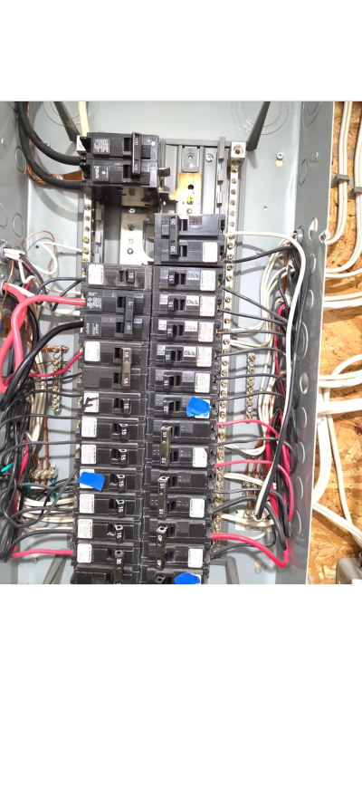 Licensed electrician performing an electrical safety inspection on a residential electrical panel in