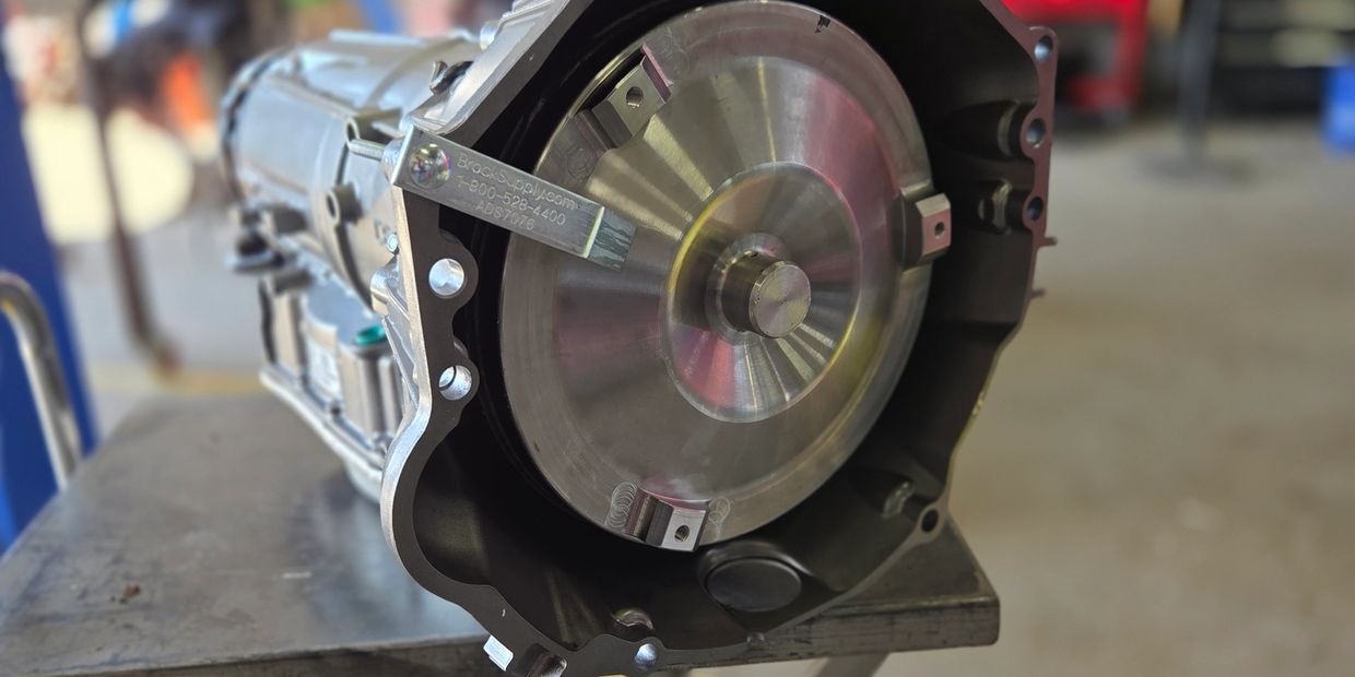 Close-up of a car transmission on a workbench in a workshop.