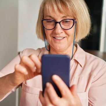 Lady with glasses using a smartphone 