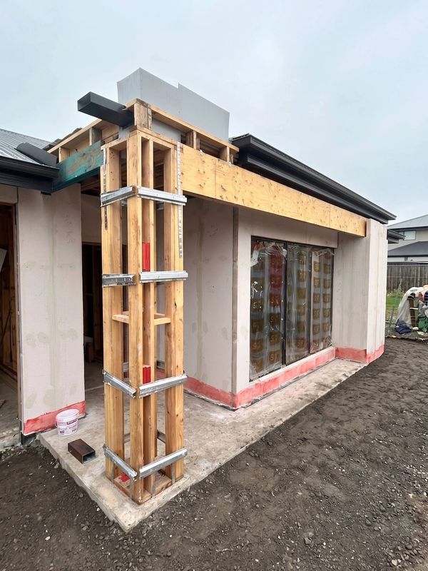 Wooden framing at the corner of a house under construction.