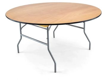 Round wooden table with metal folding legs isolated on white.