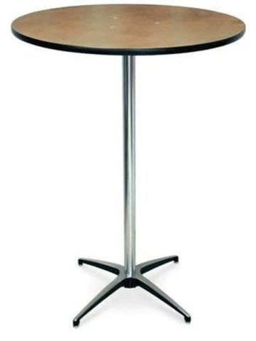 Round wooden table with metal base and four legs.