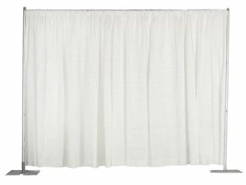 White fabric curtain hanging on a metal frame with weighted bases.