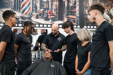 students and instructors, are actively involved in learning advanced barbering