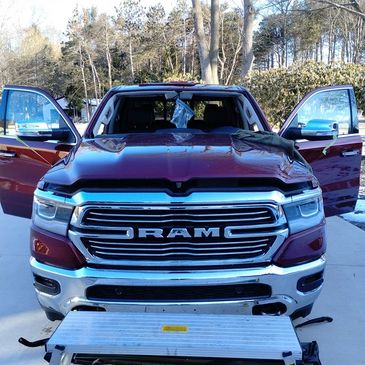 A red truck is parked in the parking lot.