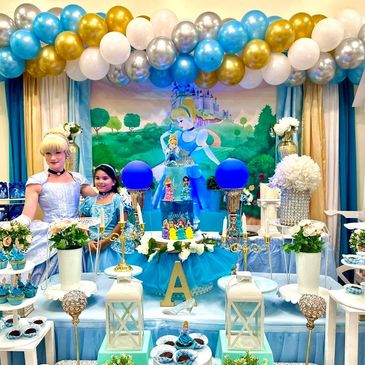 Cinderella-themed birthday party setup with blue and gold balloons.