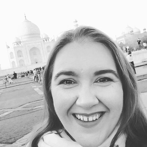 Black and white selfie a smiling woman with the Taj Mahal in the background