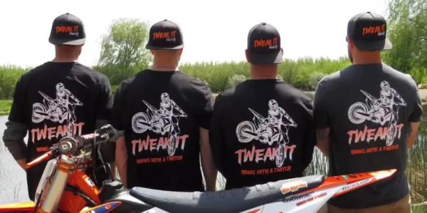 Four men with their backs faced the camera, showing off the "Tweak it Racing" shirt and hats.