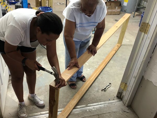 Grandmother and grandaughter build the donut counter.
