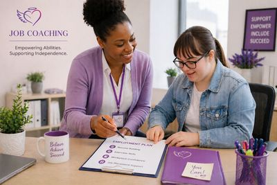 A job coach assists a young woman with an employment plan in an encouraging office setting.