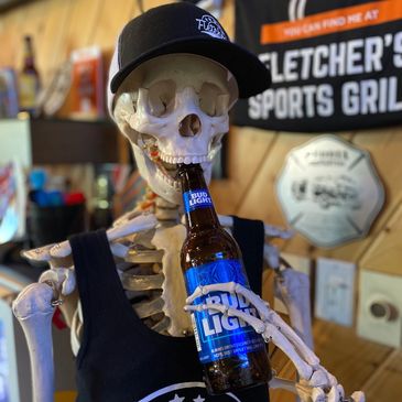 Skeleton holding a Bud Light bottle wearing a black cap and tank top.