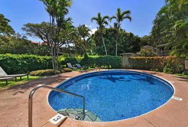 Relax by the tranquil circular hot tub surrounded by tropical greenery.