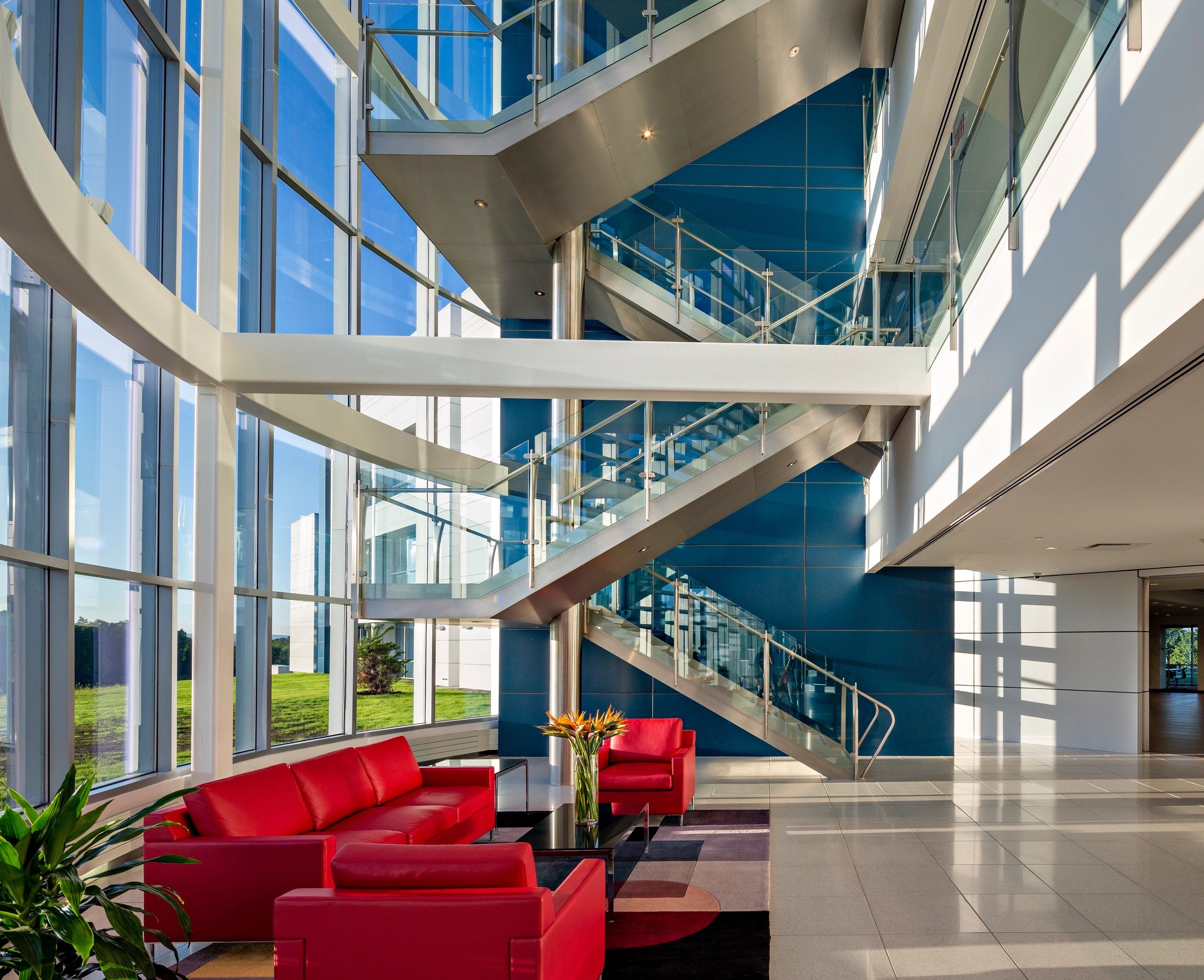 Interior space of Mediacom Headquarters featuring metal staircase and white finish fascia and canopy