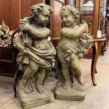 Highly detailed pair of cherub statues with excellent patina