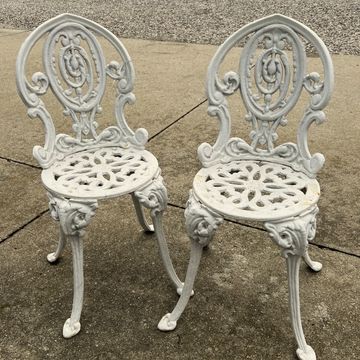 Pair of cast iron garden chairs painted white