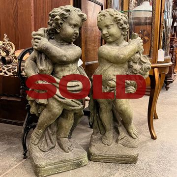 Highly detailed pair of cherub statues with excellent patina