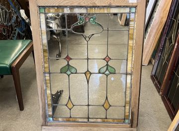 Stained and clear glass window with small details of pink, green and caramel slag glass