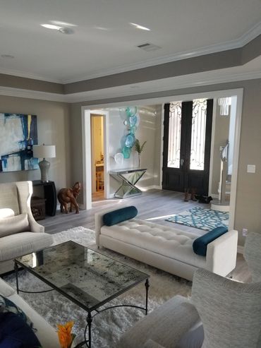 Modern living room with glass coffee table and art decor.