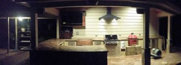 Outdoor kitchen setup with grill and counter.