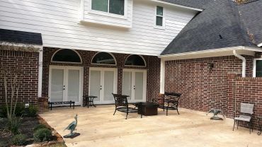 Outdoor patio area with chairs and statues.
