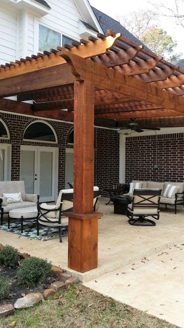 Wooden pergola with outdoor seating area.