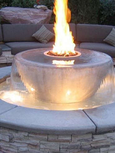 Modern fire and water feature in outdoor seating area.