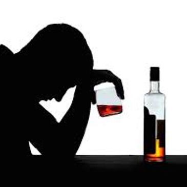man drinking alcohol looking dejected