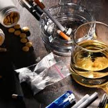 all addictive substances syringes, white powder, tablets cigarettes, alcohol in a glass, lighter