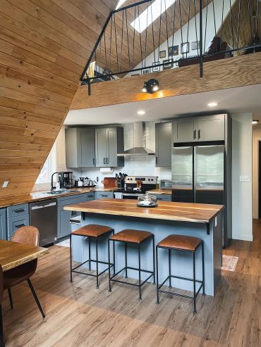 Modern kitchen with wooden accents and island seating.