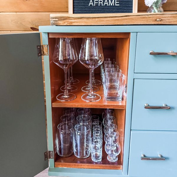 Open cabinet with organized glassware.