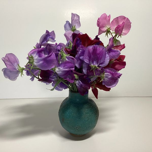 A ceramic blue vase with flowers