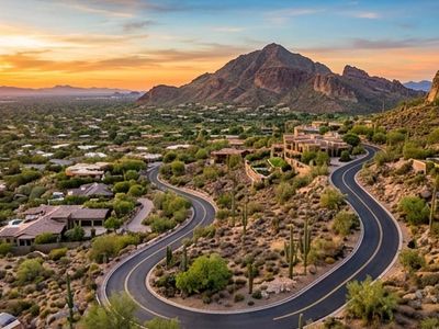 Scenic aerial view of Camelback Mountain overlooking luxury homes in Paradise Valley, Arizona at sun