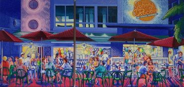 Vibrant outdoor café scene with lively crowd and colorful umbrellas at night.