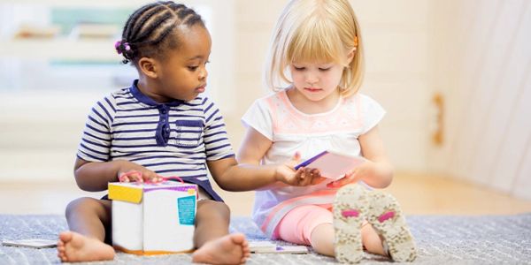 Two young children playing with toys indoors.