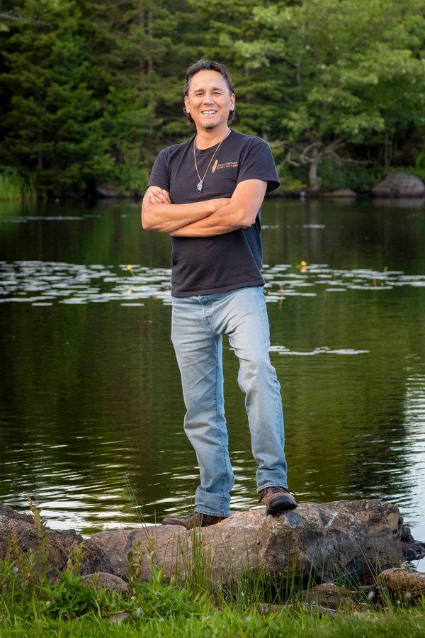 Dave Smith standing on a rock by a lake