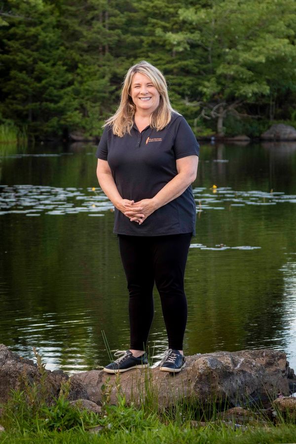 Gail Bremner standing on a rock by a lake