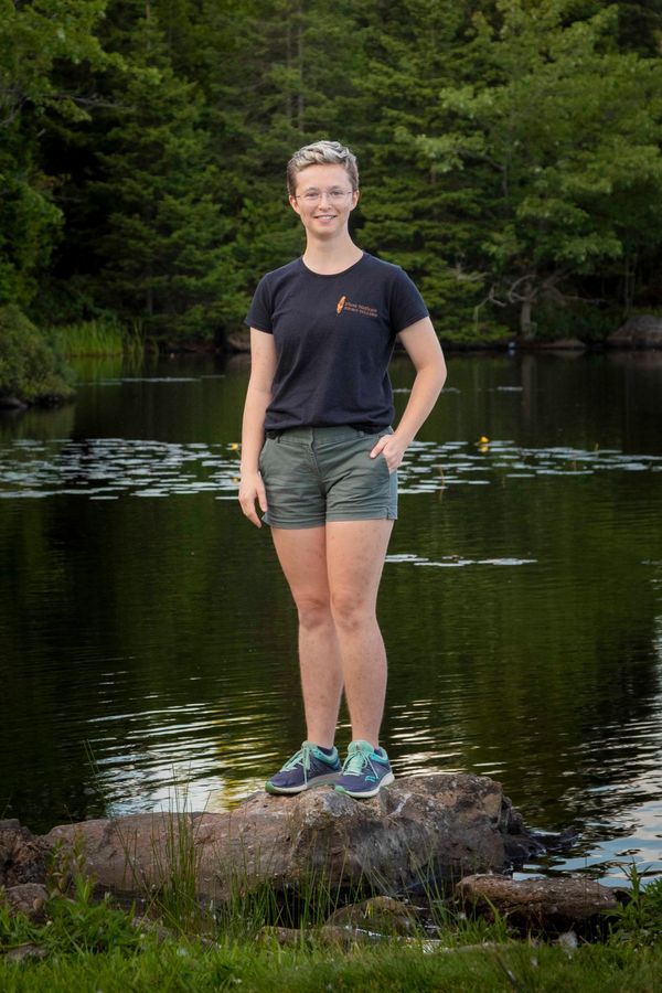 Ellis Dingee standing on a rock by a lake