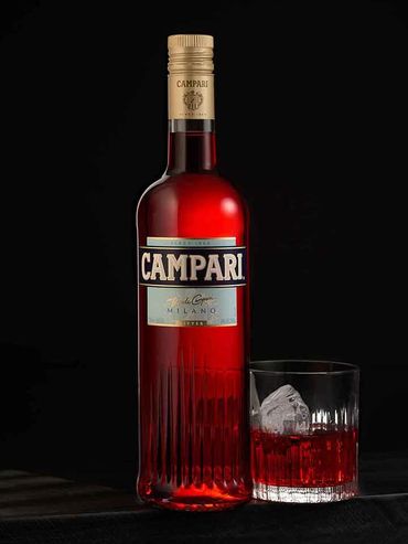 Photographer taking a picture of a premium liquor bottle on display