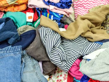 High-angle view of different kinds of used clothes for children and babies