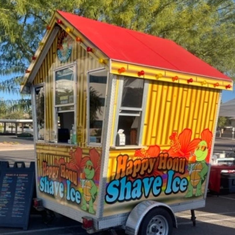 Colorful shave ice stand with a turtle mascot.