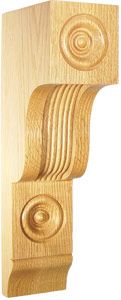 Ornate wooden corbel with carved circular designs and curved detailing.
