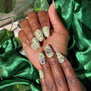 Custom press on nail set in sage green with bling in the medium oval shape.