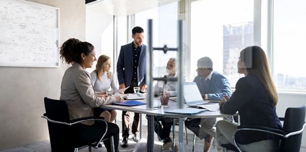 Professionals having a conversation at a conference table.