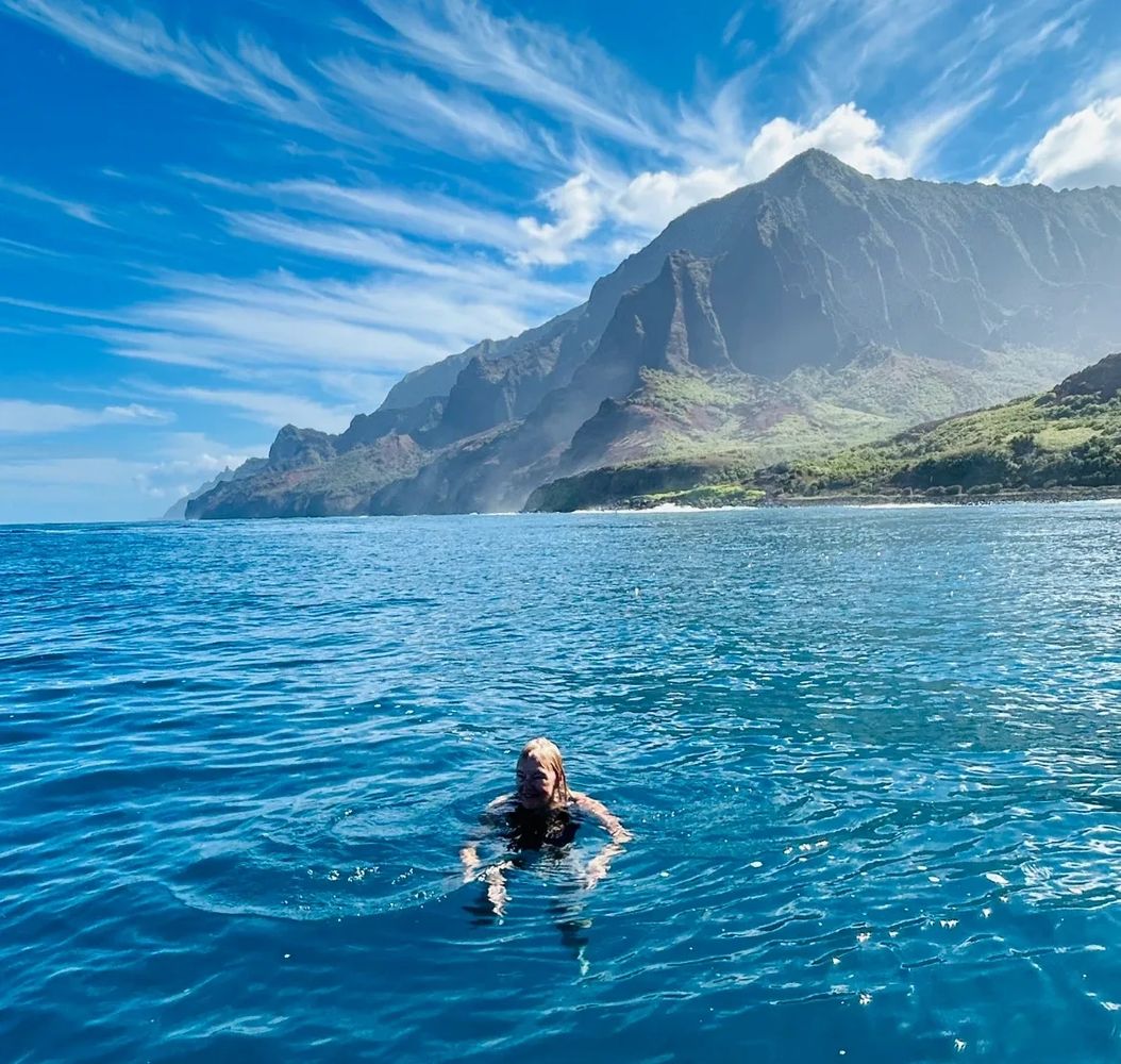 Lynda Beth swimming off the Na Pali Coast in Kauai, Hawaii.