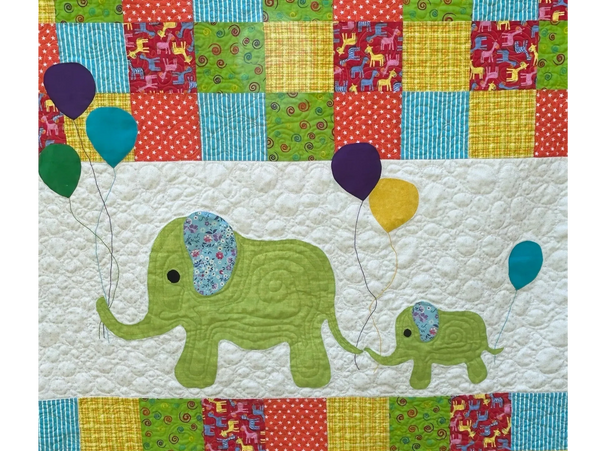 Colorful quilt featuring elephants holding balloons and patchwork patterns.