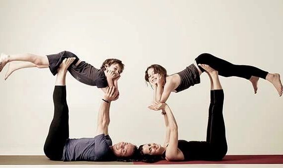 Mum and dad doing acroyoga with kids