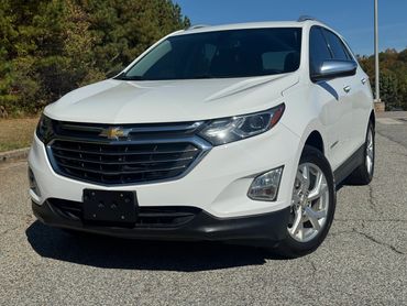 White Chevrolet SUV parked on a sunny day.