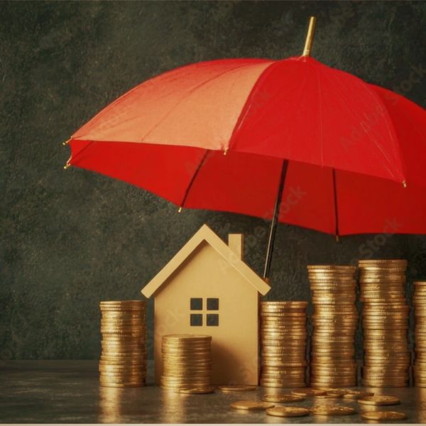 Red umbrella protecting house and stacks of gold coins.