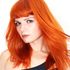 red head female model with gentle wind blowing hair over their left shoulder